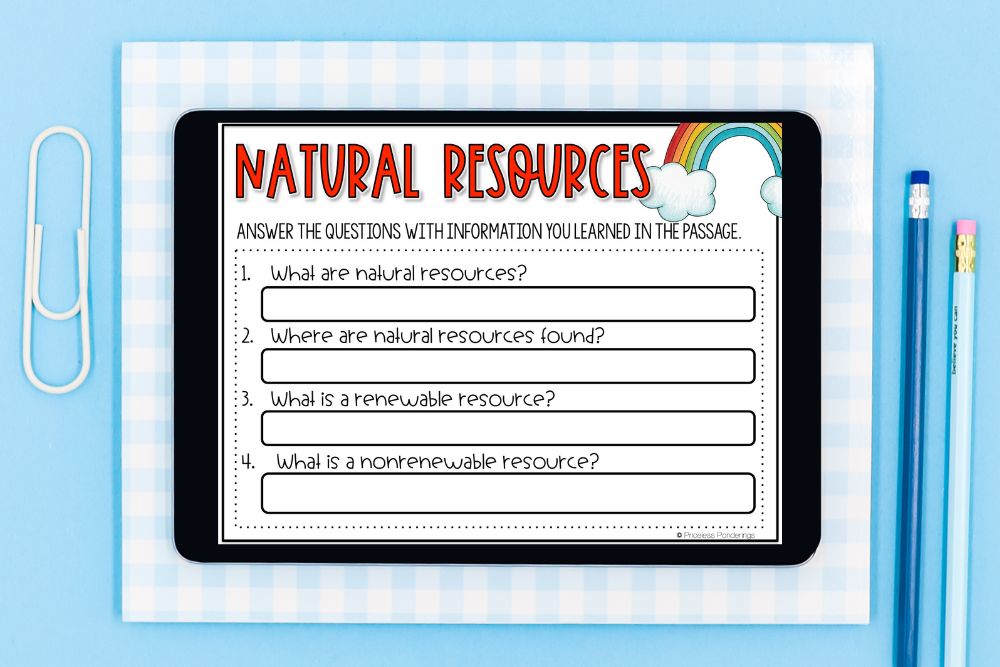 Natural Resources Lesson Plans Kids Will Love A tablet showing a Natural Resources reading comprehension activity with four questions about what natural resources are, where they are found, and the difference between renewable and nonrenewable resources, on a blue gingham background.